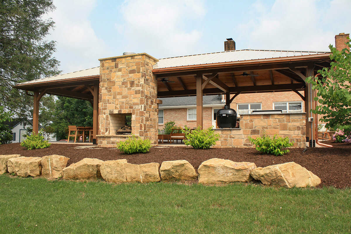 rustic-retreat and fireplace outside with landscape in view